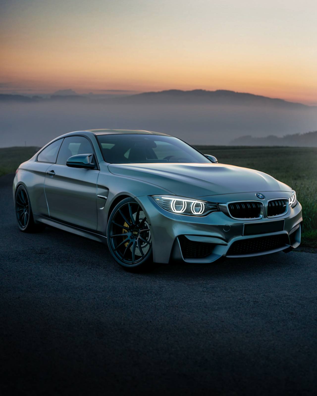 Grey coupe parked at sunset