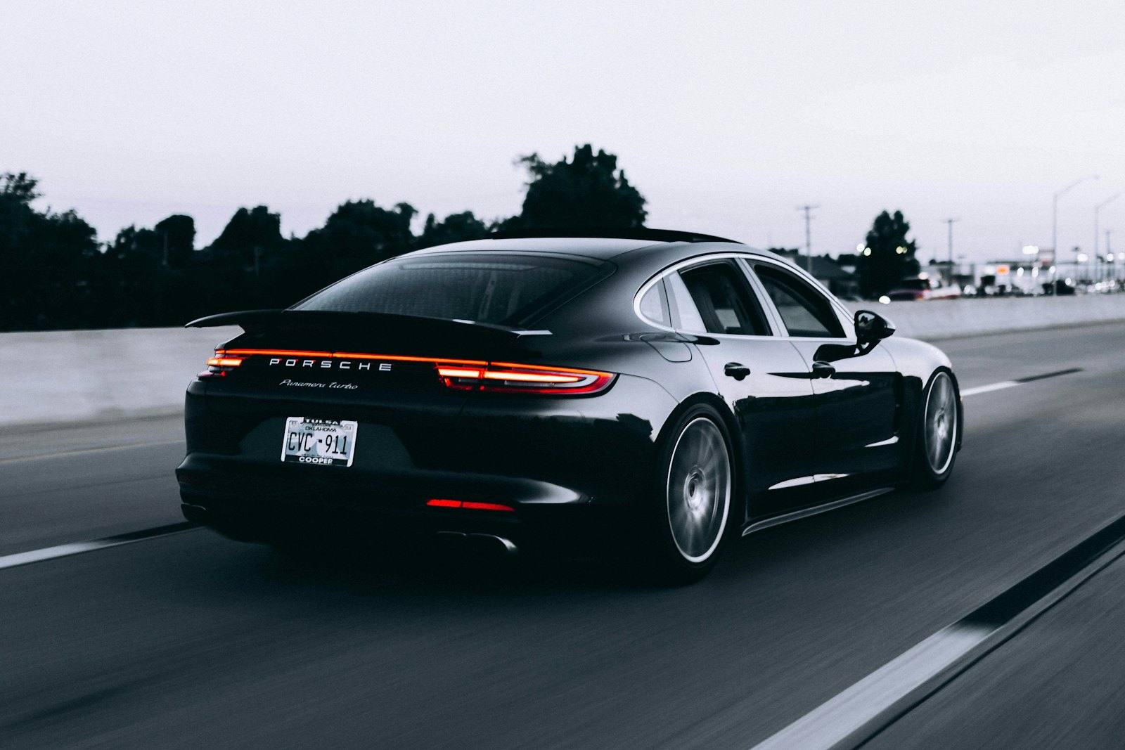 Black sedan driving on a highway